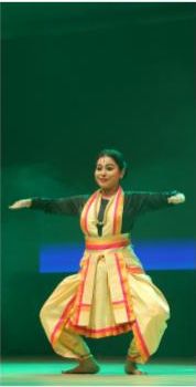 Girl performing traditional dance at a Dhanu Bihar event